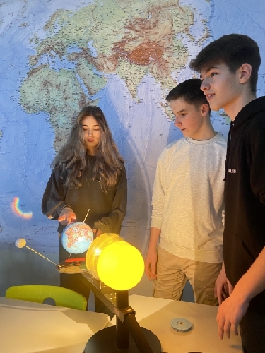 Schüler schauen sich ein Modell des Sonnensystems an